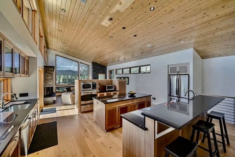 Gourmet kitchen with high-end appliances, island seating, and open layout