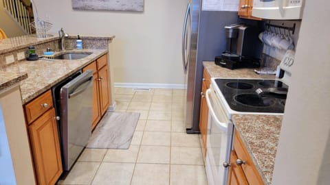 well stocked kitchen with all appliances and extra refrigerator in garage