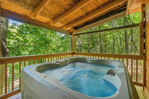 Unwind in your private outdoor hot tub overlooking tranquil forest views, the perfect end to a day of hiking or lake fun.
