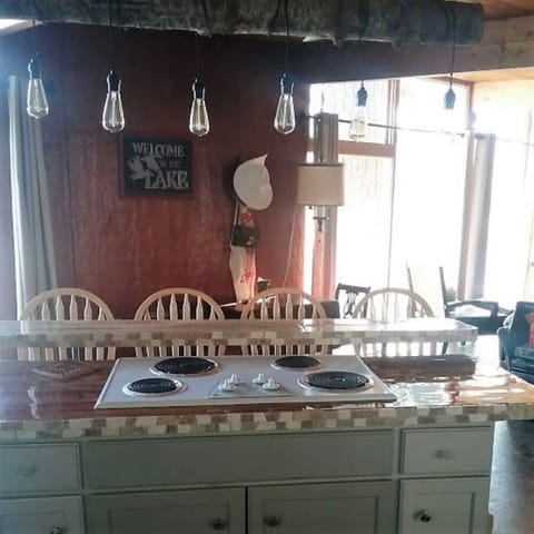 Four seat kitchen island with stove top.  Notice the lighting fixture!  