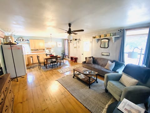 Living area with single futon. Dining table. Kitchen.