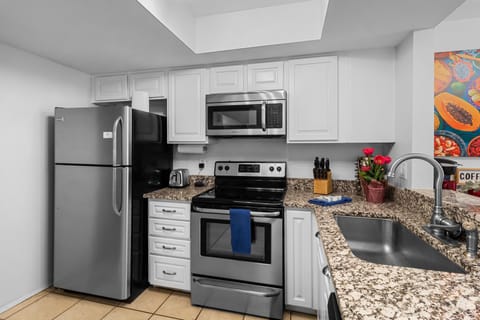 Kitchen with blender, toaster microwave, pots, spices, oil