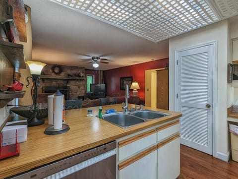 View from Main Level Kitchen to Den with Fireplace
