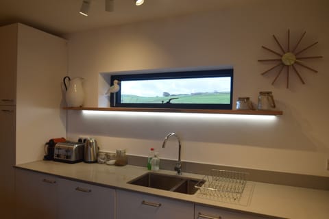Mood lighting in the kitchen with views over the field. Granite worktops.
