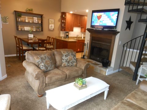 Living / Dining. Spiral stairs case to loft.