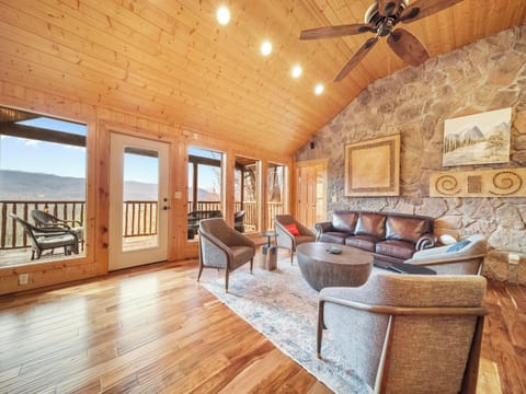 Spacious Living Room with Panoramic Mountain Views Through Grand Windows