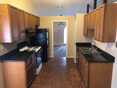 Kitchen is the hub of the home and features black appliances.