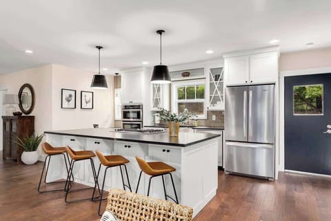 To the left of the living room, you'll find our spacious kitchen complete with a HUGE island with four barstools and a state-of-the-art cooktop.