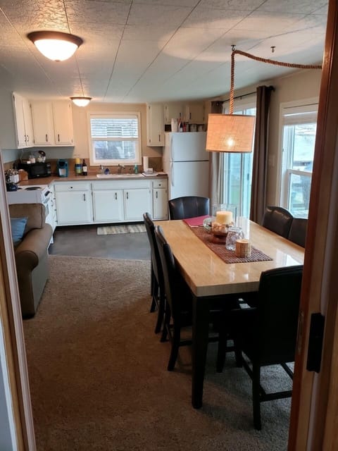 View from sun room into kitchen, dining space, and living room.