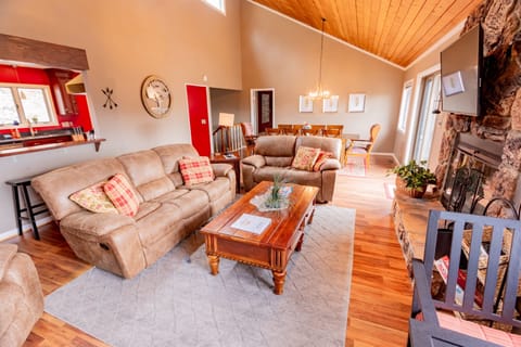 Comfy living room with views of the slopes and a wood-burning fireplace.