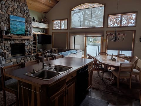 Open Living/Kitchen/Dinning vaulted with fireplace ans lake view