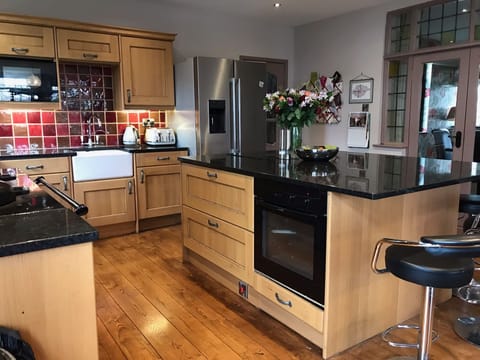 A huge family/kitchen room with AGA, oven, hob,  and SMEG fridge freezer.