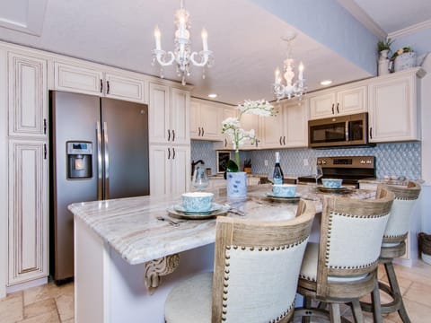 Comfortable bar stools complement marble kitchen island