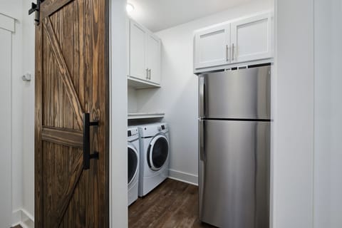 Downstairs laundry room with extra refrigerator