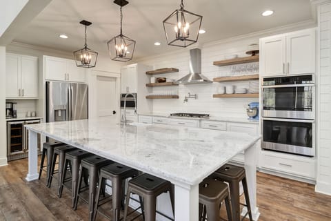 Kitchen has a double oven and 5 burner range with power-boil setting