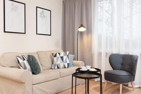 The elegant living room featuring a comfortable beige sofa perfect for relaxation.