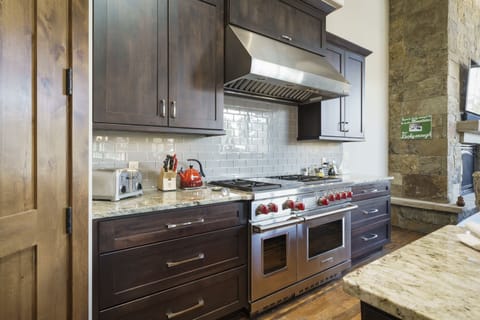 The large kitchen has top of the line appliances and is stocked with everything you may need to cook dinner at home.