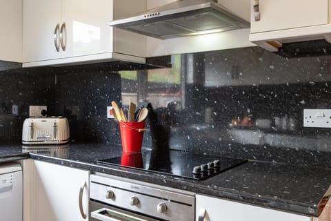 Well equipped kitchen with full size oven and easy clean hob
