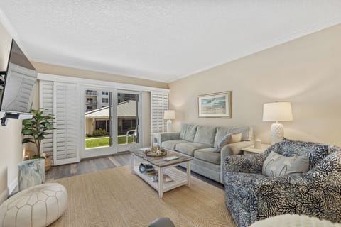Spacious living room area with access to the patio.