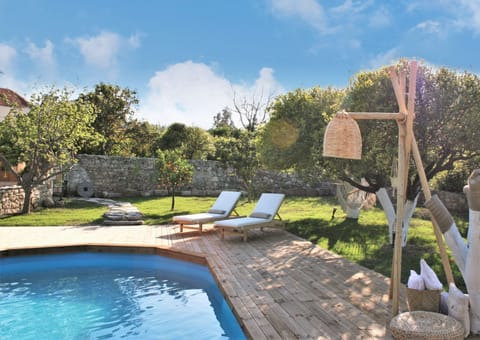 swimming pool with sunbeds