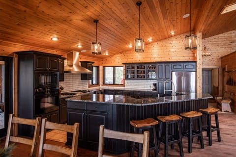 Bar stools along kitchen counter is great for socializing and extra seating cap.