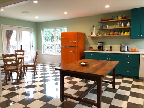 Main house kitchen with door to deck and grill