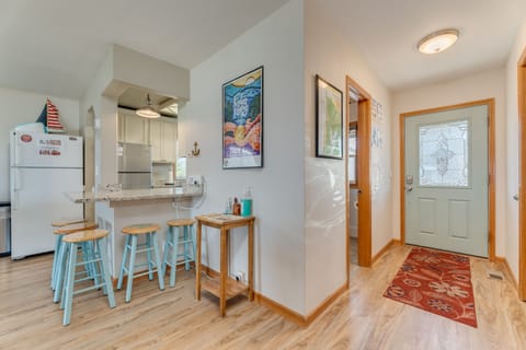 Entryway with adjacent bathroom, laundry room, dining area, bedroom and kitchen.