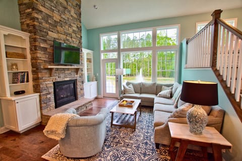 Your Family Room on Main Floor w Sloped Ceilings and View of Pond and Woods