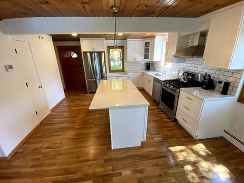 Brand new kitchen with quartz countertops and new appliances.