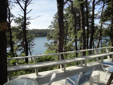 Deck overlooking white pond with seating around perimeter