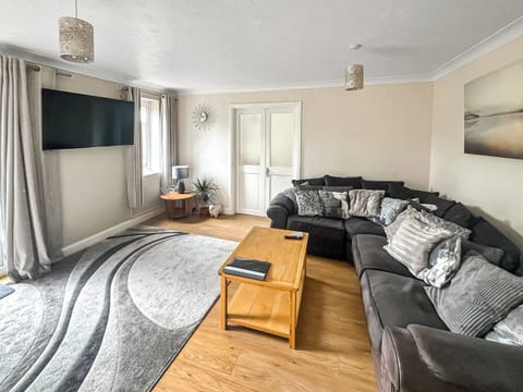 Stylish living room with door to patio and garden | Britannia Way, Westward Ho!