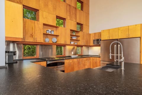 Kitchen with double ovens, double refrigerators, dishwasher and large sink