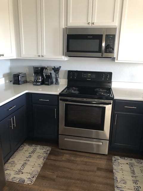 Kitchen with toaster. Blender. Can opener. Drip coffee pot. 