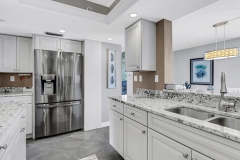 Kitchen overlooking dining area. Refrigerator with extra craft ice maker.