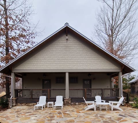 The rear patio of the bungalows with patio furniture, firepit, and gas grill.