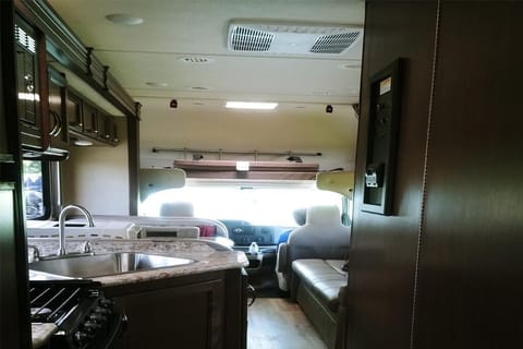 View from the bedroom to the front of RV. Bedroom has a roll back door.