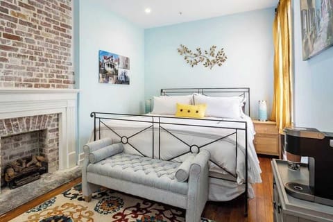 a comfortable king bed with a romantic fully working gas fireplace