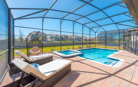 Private pool with removable mesh fence, jacuzzi, and loungers.