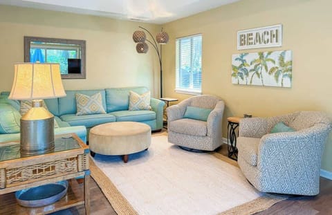 Cozy living room with comfortable seating and beach-themed decor.