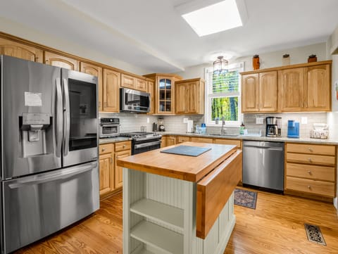 A bright, open kitchen made for gathering — with forest views, modern appliances, and that inviting mountain warmth.