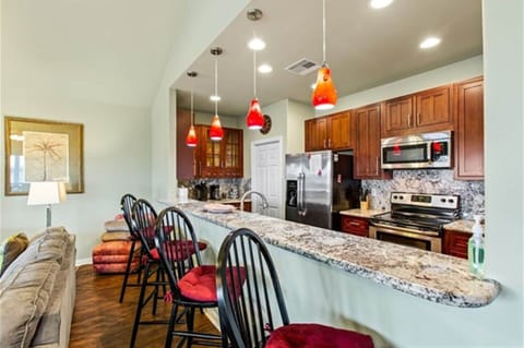 Open kitchen with breakfast bar, ideal for morning coffee and easy conversation.