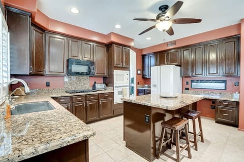 Fully stocked kitchen has double ovens, plentiful counter space and additional seating at the breakfast bar.