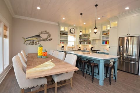 Dining room with 8 seats and 6 bar stools plus ice maker.