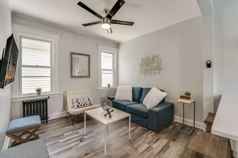 Living room with couch, seating, and TV with Roku & Netflix