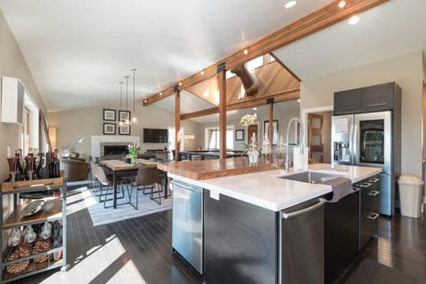 High-end, modern kitchen w/ stainless steel amenities, unique granite wood counters, and lots of space.