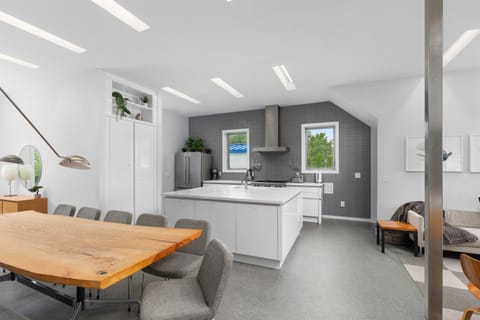 Open concept kitchen and dining room.  Live edge dining table with seating for 13, plus 4 in nearby nook