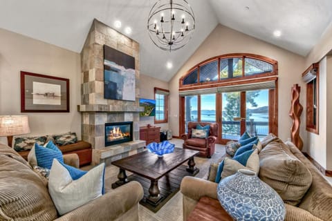 The great room is the ultimate gathering space with a warm fireplace, 55" HDTV w/ cable & streaming, and glass doors to the balcony overlooking the lake.