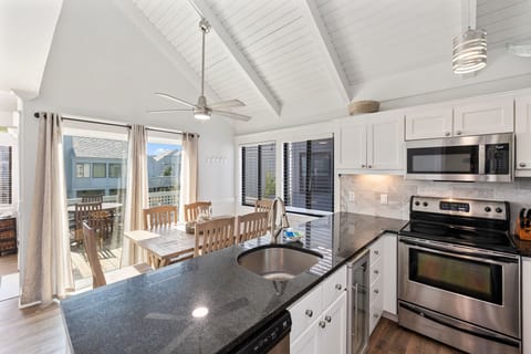 Kitchen open to dining area and living room with access to porch