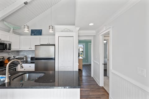 Hallway from kitchen to queen bedroom with dual access to full bathroom