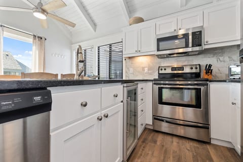 Kitchen open to dining area and living room with access to porch